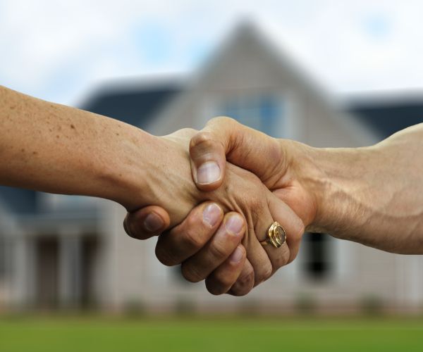 handshake between a professional and a homeowner